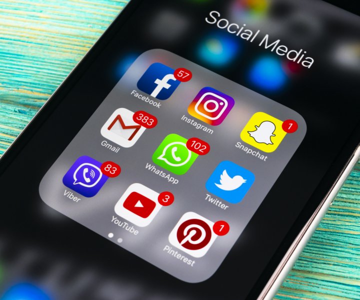 Sankt-Petersburg, Russia, November 13, 2017: Smartphone with icons of social media on screen on green wooden table. Smartphone life style smartphone. Starting social media application whatsapp, viber, facebook, instagram, twitter, pinterest. Photo taken in Business center November 13 2017