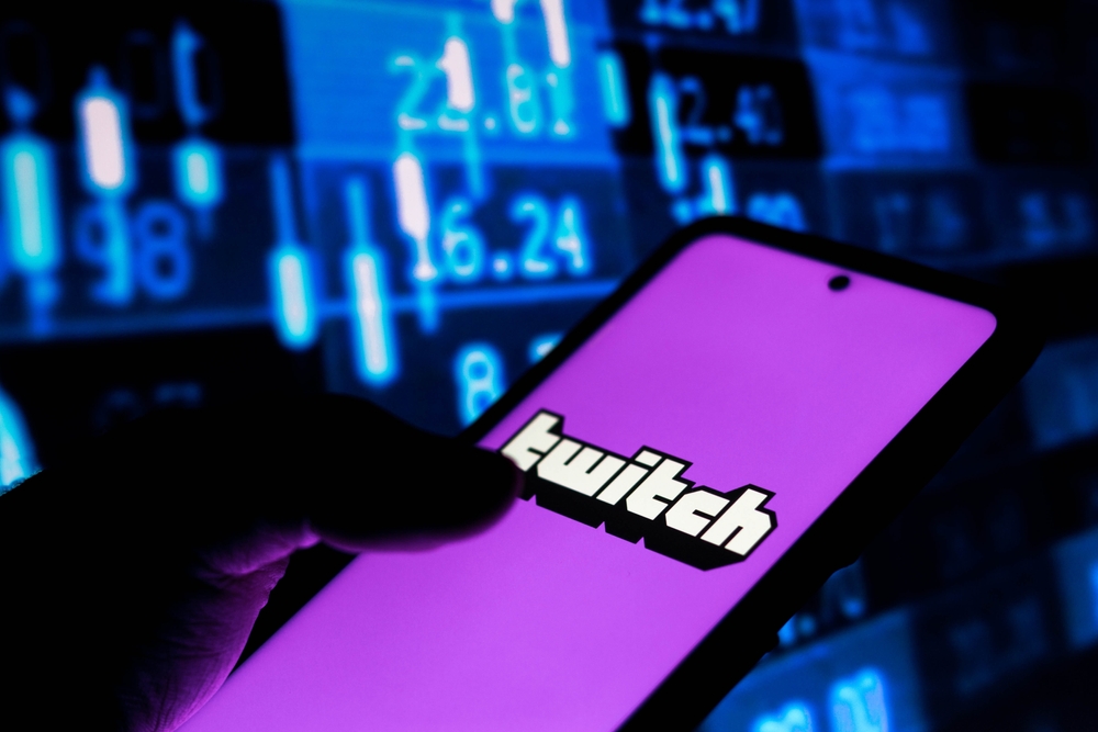 Twitch-graphic-displayed-on-smartphone-with-analytics-screen-behind