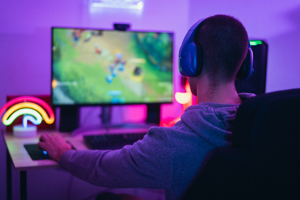 Young-gamer-playing-an-online-video-game-on-desktop-computer