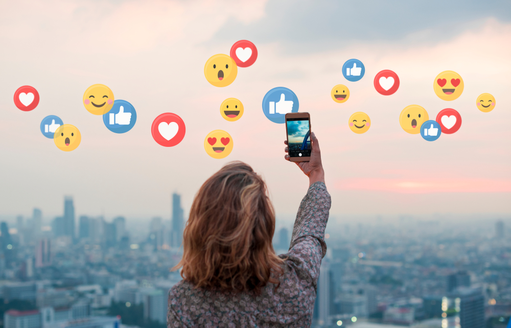 Woman-taking-photo-of-city-skyline-while-social-media-reactions-float-by