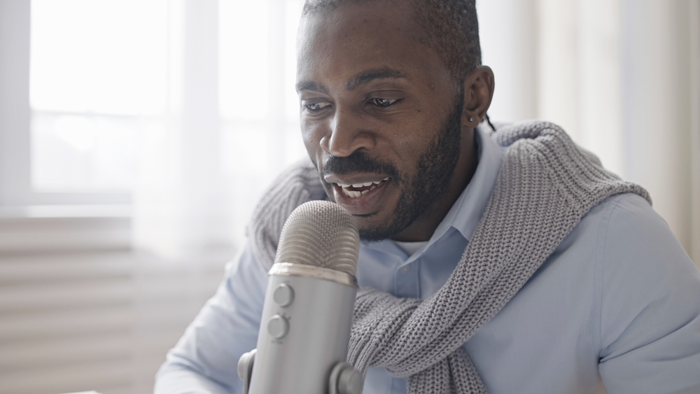 African-American-male-recording-podcast-with-microphone