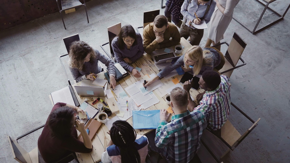 Diverse-business-team-brainstorming-around-table.