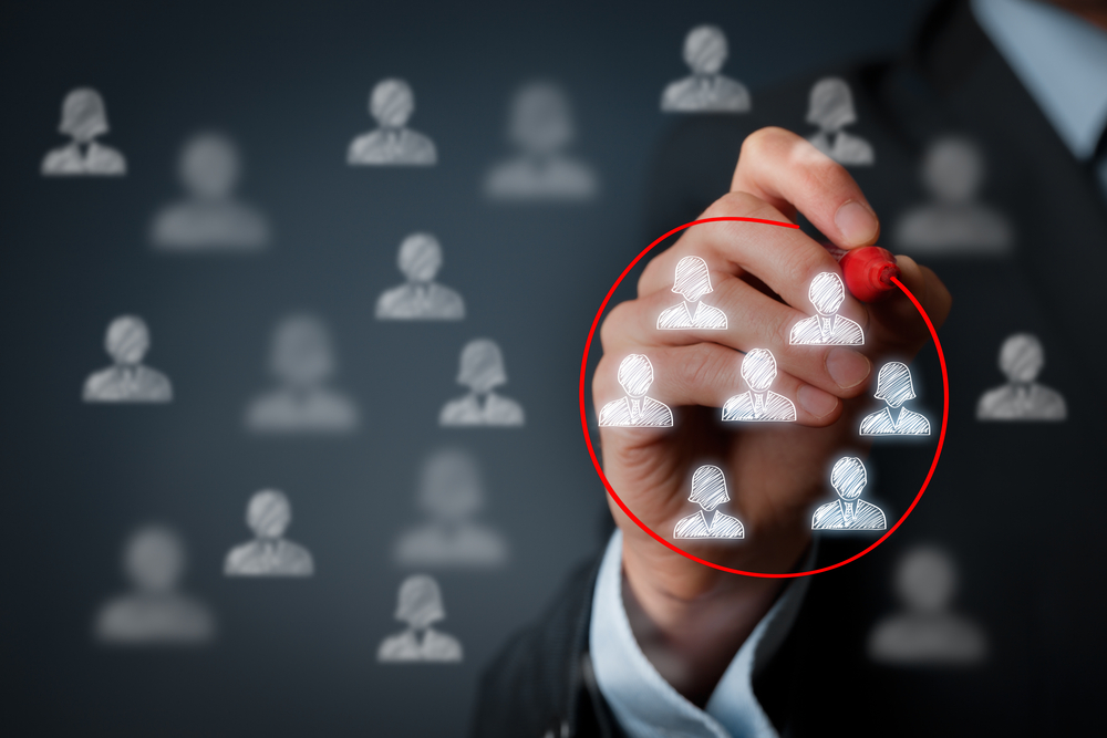 Man-circling-people-icons-on-drawing-board