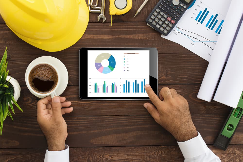 Businessman-using-tablet-to-view-graphs