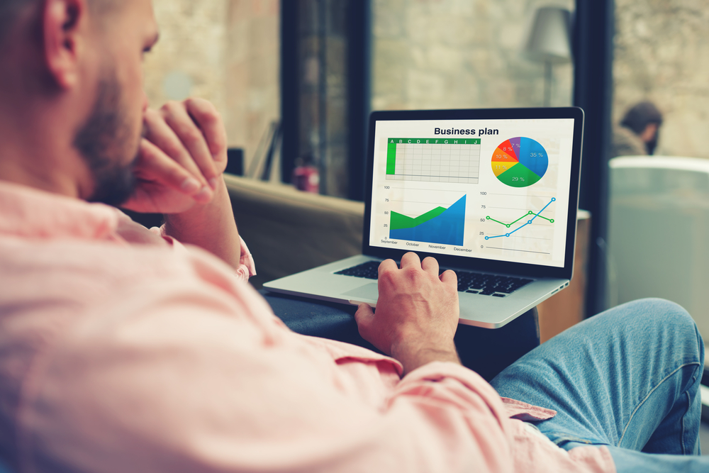 Businessman-looking-at-financial-data-on-a-laptop