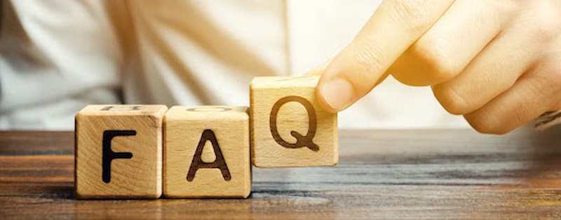 Man-setting-up-wooden-blocks-with-letters-FAQ.